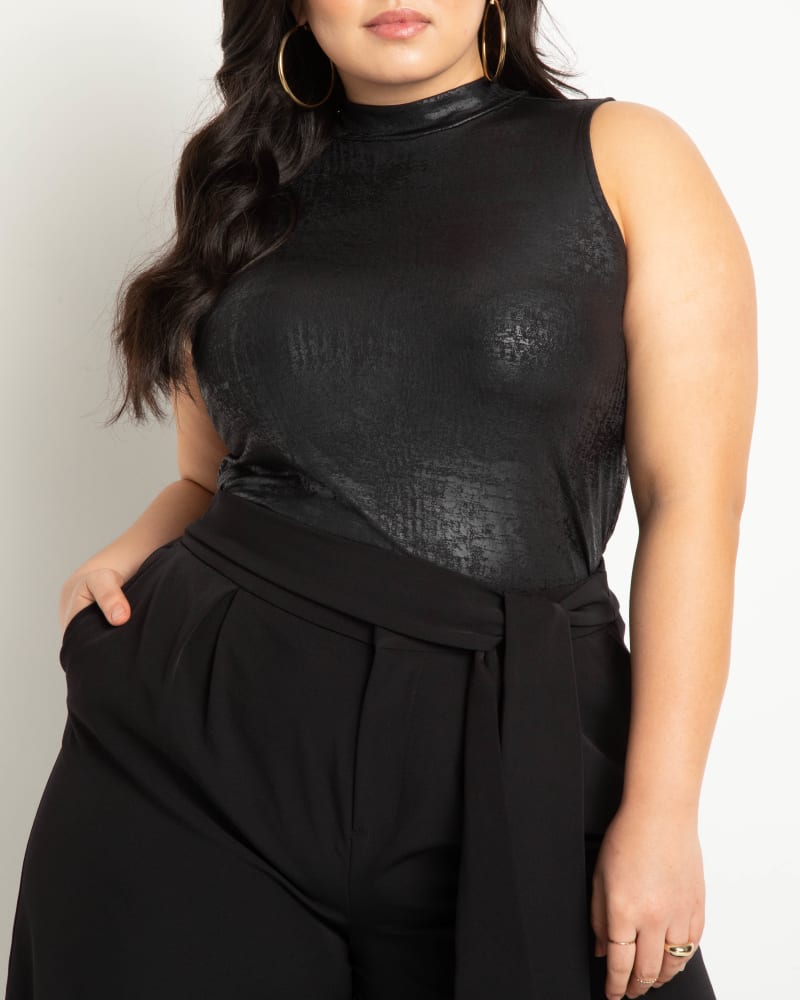 Front of a model wearing a size 18 Coated Knit Mock Neck Top in Black Onyx by ELOQUII. | dia_product_style_image_id:273566